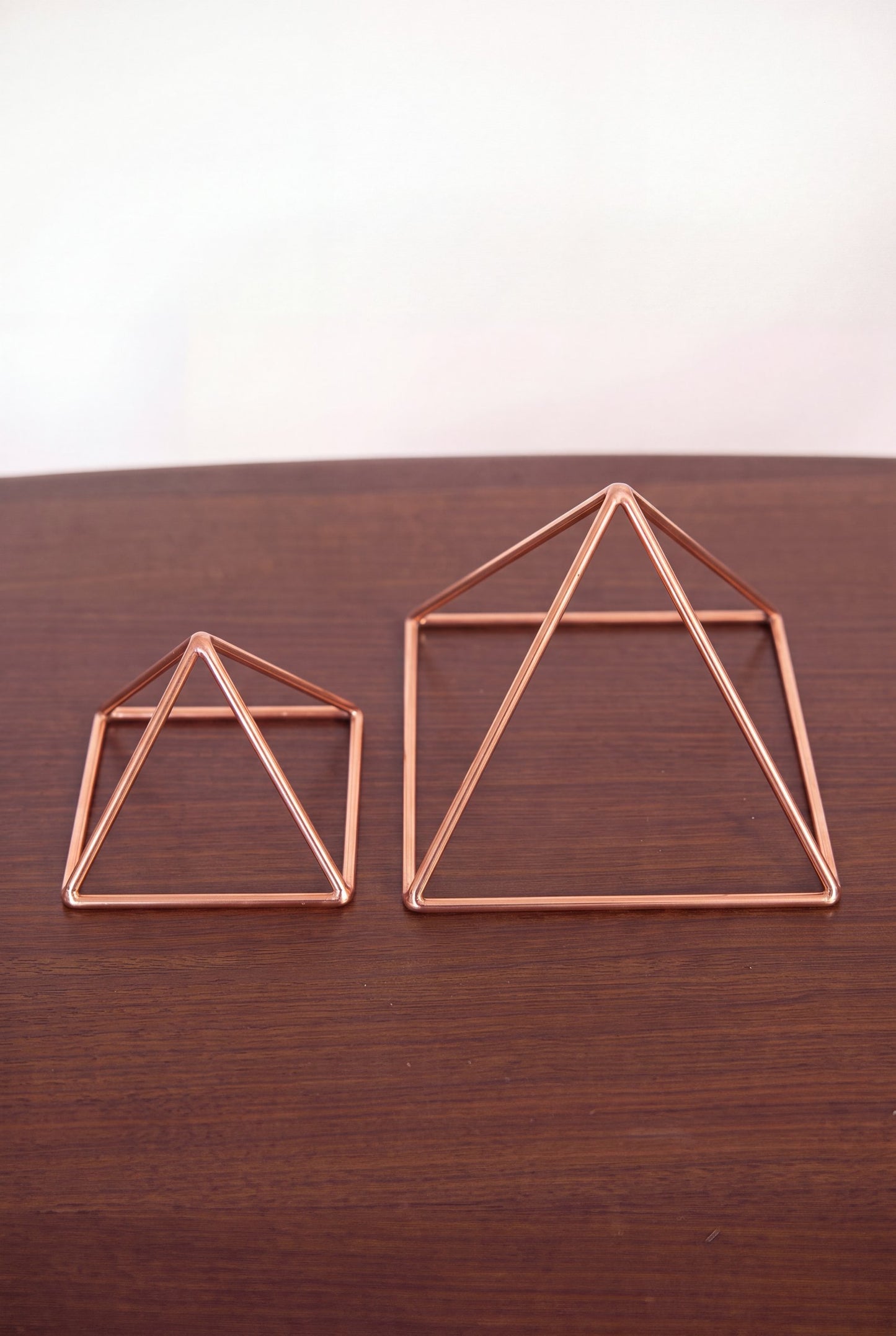 Kopero Koperen Piramide Energizer Glad, beide maten naast elkaar op een houten tafel